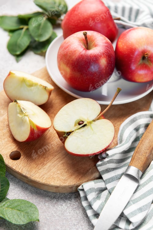 Preview: Fresh red apples slicing on wooden board