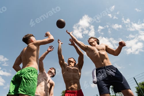 Preview: four sexy shirtless sportsmen playing basketball under blue sky