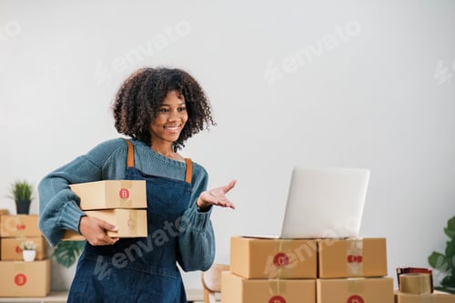 Preview: Startup small business entrepreneur SME, asian woman packing cloth in box. Portrait young Asian