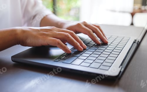 Preview: Closeup image of a woman hands working and typing on laptop computer keyboard