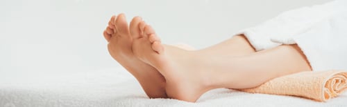 Preview: panoramic shot of adult woman lying on beige towel in spa