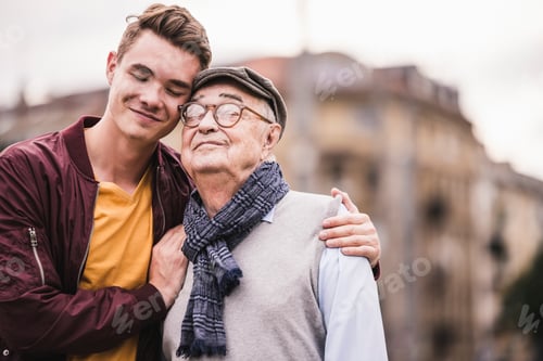 Preview: Portrait of happy senior man head to head with his adult grandson