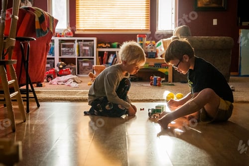 Preview: Two Children Playing with Toys on Floor Indoors