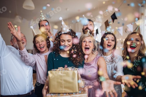 Preview: A portrait of multigeneration family with presents on a indoor birthday party.