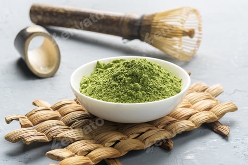 Preview: Matcha tea powder in a bowl on a gray concrete background.