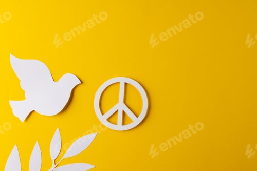Preview: High angle view of white peace sign, white dove and leaf with copy space on yellow background