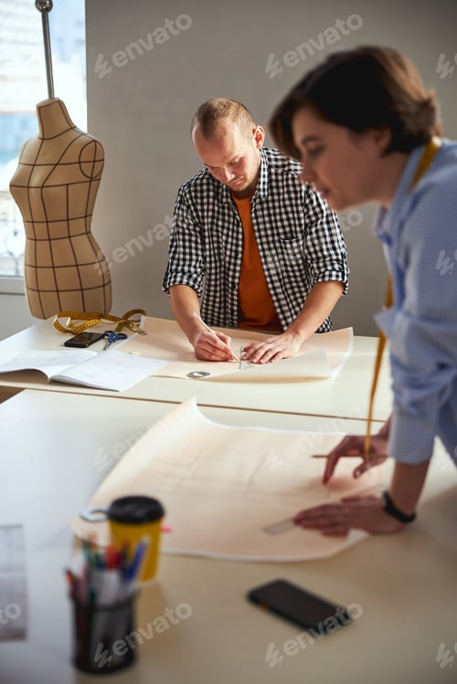 Preview: Concentrated man drawing a line on paper