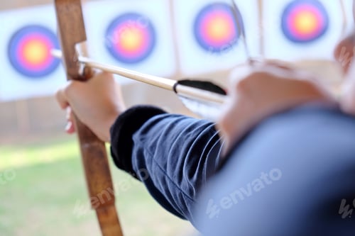 Preview: Archer holds his how aiming at a target