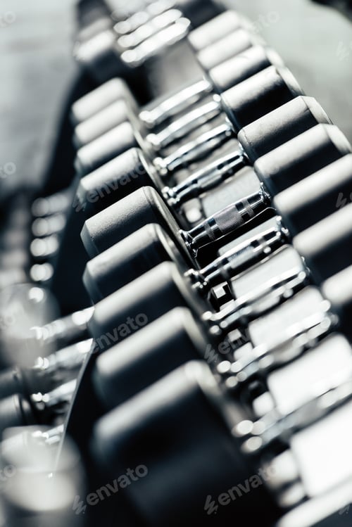 Preview: selective focus of row of dumbbells in gym