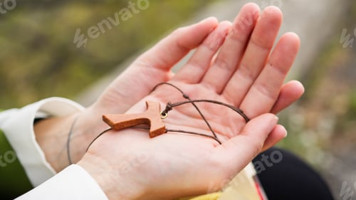 Preview: Woman's Hands Clasp Crucifix