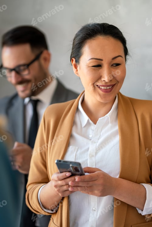 Preview: Middle aged asian business woman working on the phone at corporate office