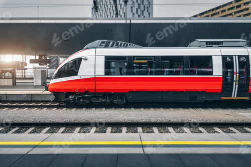 Preview: High speed train in motion on the railway station at sunset