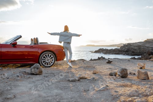 Preview: Woman traveling by car on the rocky coastline