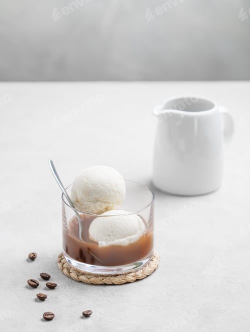 Preview: Affogato coffee with vanilla ice cream scoops and espresso in a glass on a light background