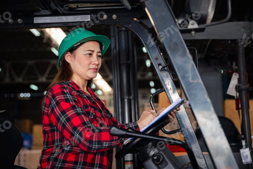 Preview: Portrait of an Asian woman an adult female engineer skillfully driving a forklift in an industrial