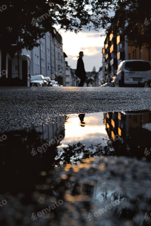 Preview: Low angle shot of reflection in a puddle on the street after the rain