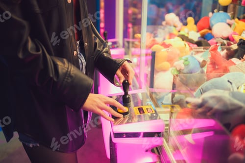 Preview: Person standing in front of machine filled with stuffed animals indoor entertainment center