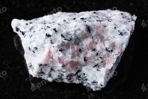 Preview: raw miaskite with pink cancrinite mineral on black
