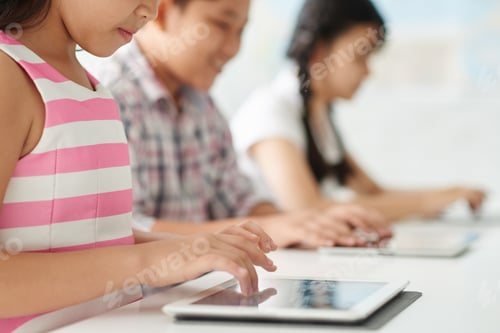 Children Learning Together Using Tablets in Classroom