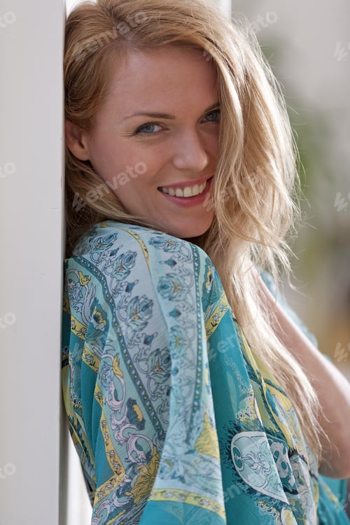 Preview: Young Woman At Home In Summer Dress Against A White Wall