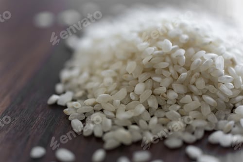 Preview: Paella Rice In A Pile On A Wooden Surface