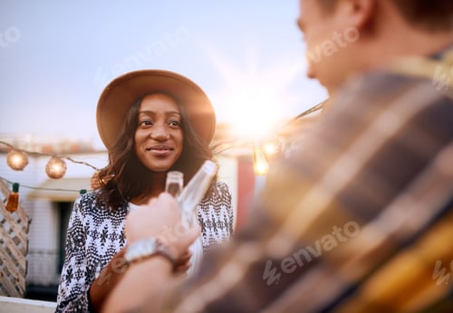 Preview: Multi-Ethnic Millenial Couple Flirting While Having A Drink On Rooftop Terrasse At Sunset