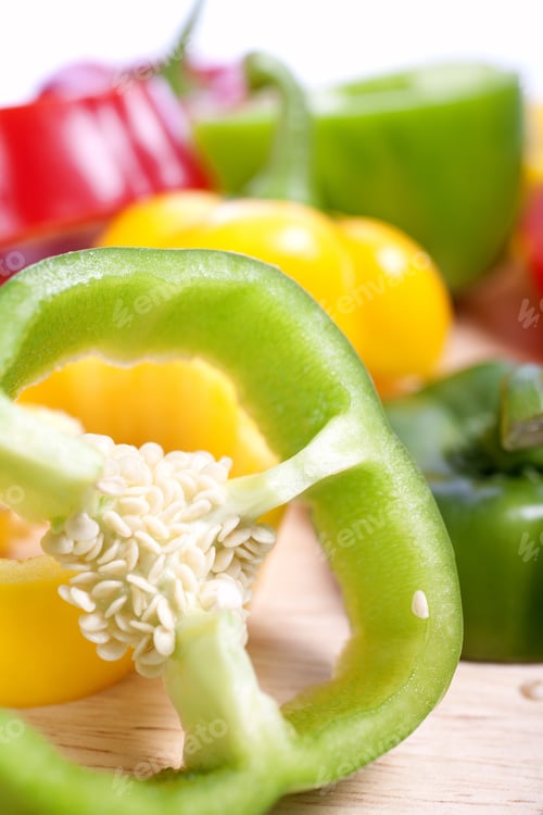 Preview: Red Yellow And Green Peppers Sliced On An Isolated White Background