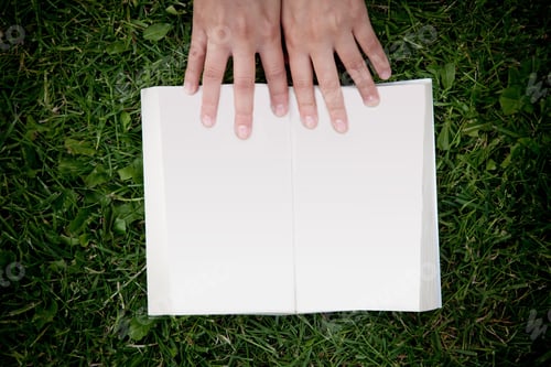 Preview: Person Lying On The Grass Outdoors Reading A Book