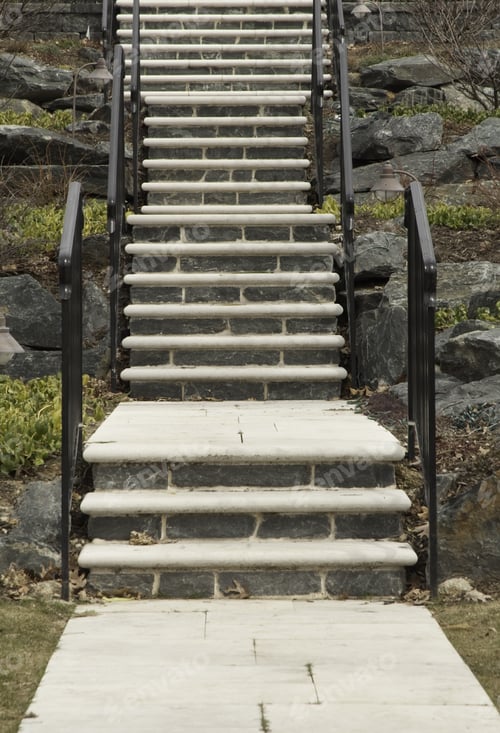 Preview: Stone And Concrete Stairway With Black Iron Railings Up Rocky Hillside