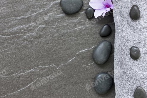 Preview: Spa Treatment Stones And Towel Border On A Tiled Floor Conveying Tranquility