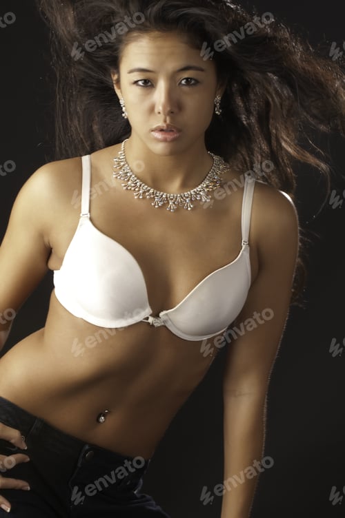 Preview: Pretty Young Asian-American Woman In White Brassiere And Jeans