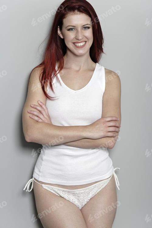 Preview: Attractive Woman In White Bikini Bottoms And Vest Top Posing