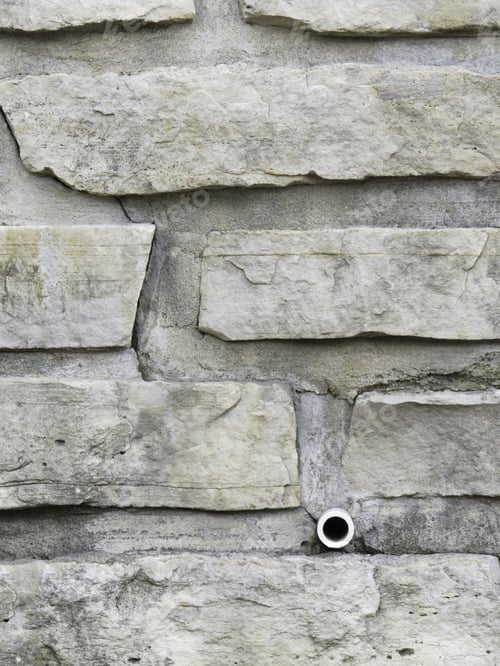 Preview: Stone Retaining Wall With Unobtrusive Drainage Pipe