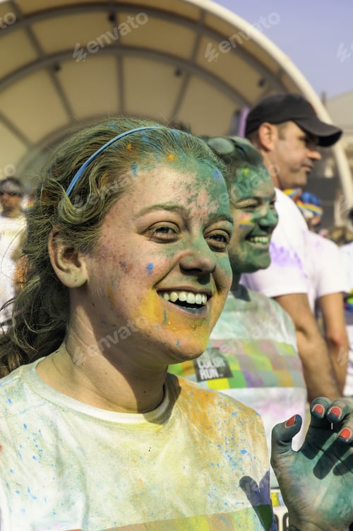 Preview: Kalamazoo, Michigan, Usa - April 12, 2014: A Young Woman Runner Beams After A Dousing Of Colored