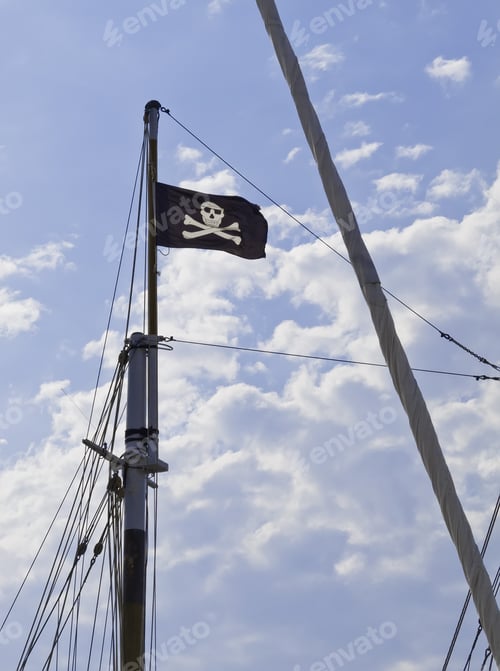 Preview: Jolly Roger Flapping In A Breeze On Tall Mast Of Sailboat