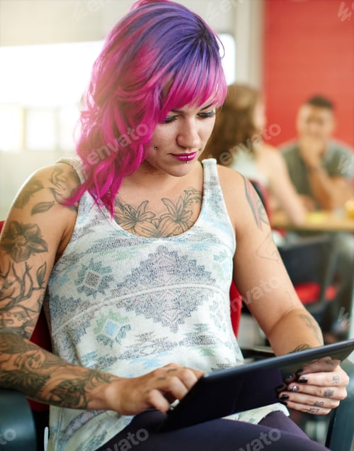 Preview: Confident And Edgy Female Designer Working On A Digital Tablet In Red Creative Office Space