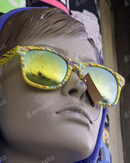 Preview: Portrait Of Serene Mannequin With Cracked Face, Eyes Hidden Behind Tropical Sunglasses With Colored