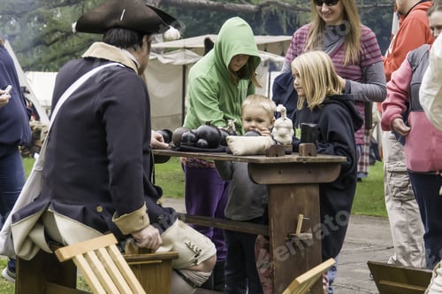 Preview: Wheaton, Illinois/Usa - September 13, 2014: A Boy Reaches For A Cannonball On Display While Family
