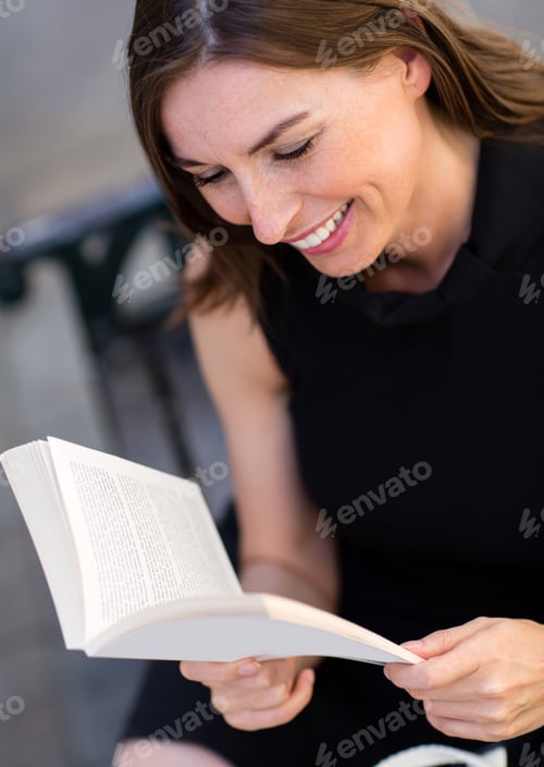 Preview: Business Woman Reading A Book And Looking Happy