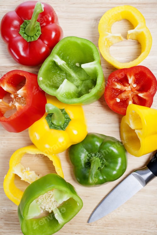 Preview: Selection Of Red Green And Yellow Peppers Sliced Up On A Chopping Board