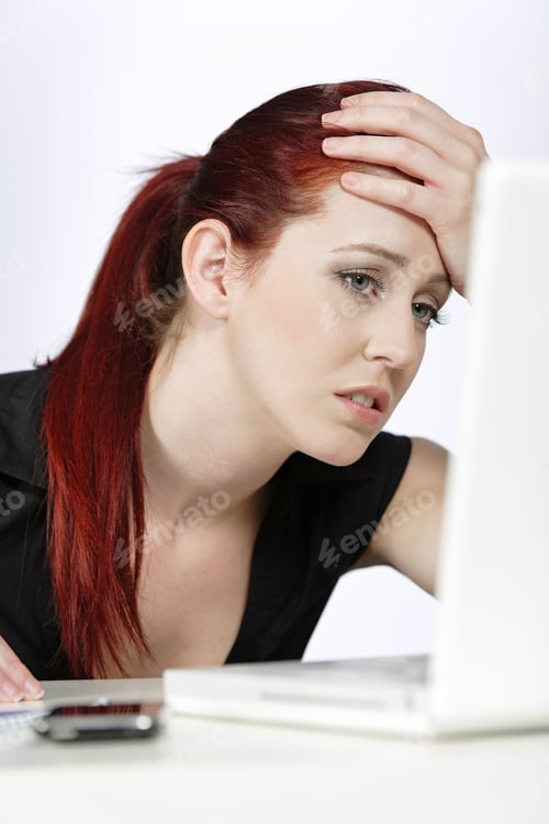 Preview: Professional Woman Showing Concern At Work Using Her Laptop