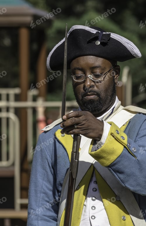 Preview: Wheaton, Illinois/Usa - September 12, 2015: A Black Soldier Attaches A Bayonet To His Musket In A