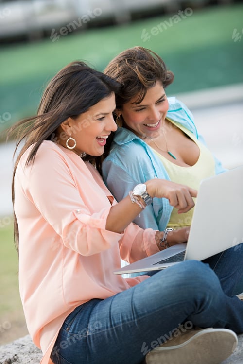Preview: Girls Using A Laptop Computer Outdoors And Looking Very Happy