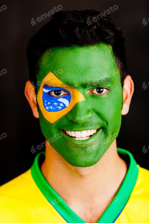 Preview: Brazilian Man With Flag Painted On His Face - Isolated Over A Black Background