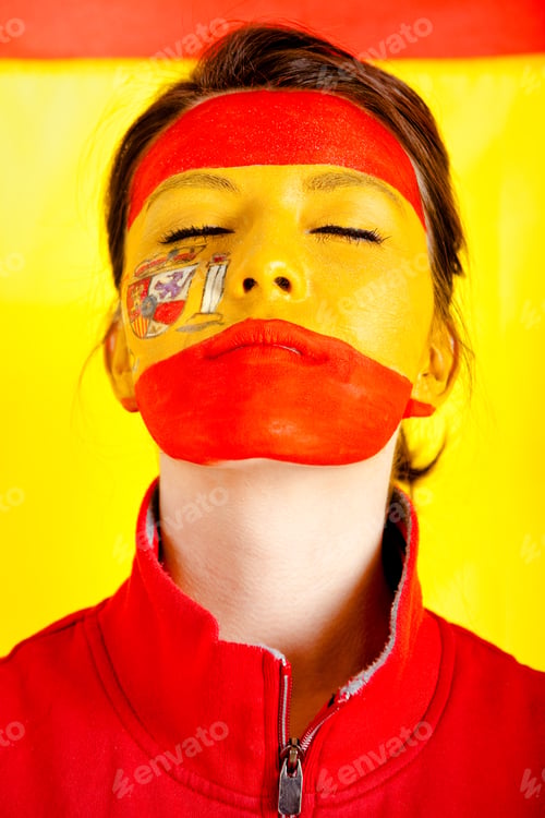 Preview: Patriotic Spanish Woman With The Flag Behind Her And Paint On Her Face