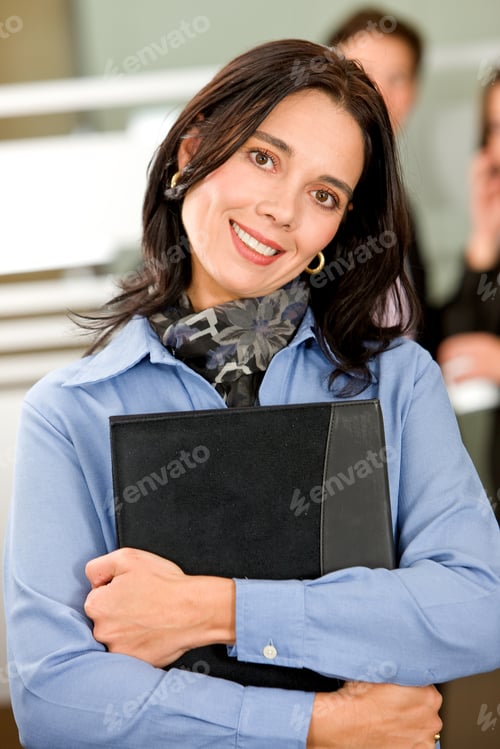 Preview: Business Woman Smiling Holding A Folder At Her Office