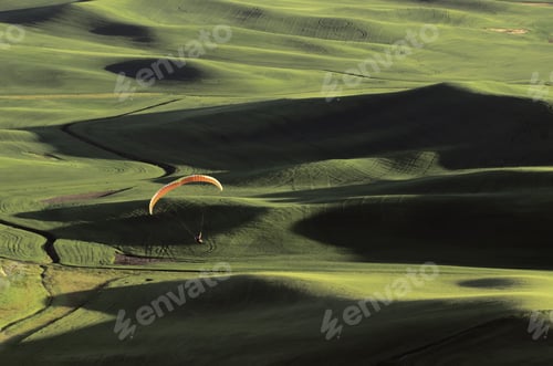 Preview: Paraglider Descending Toward Green Hills Of The Palouse In Western Washington, Usa, As Sunset