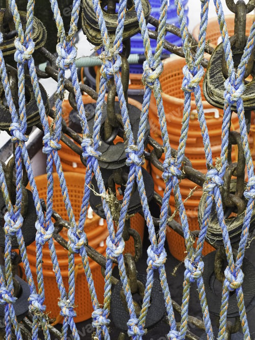 Preview: Restraint Of Knotted Blue Rope Near Stacks Of Orange Buckets Aboard Commercial Fishing Boat