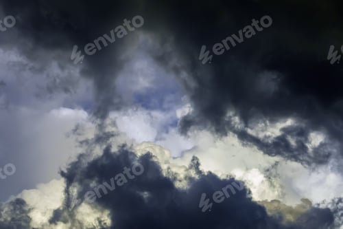 Preview: Approach Of A Storm: Dark Clouds Obscure More Distant Cumulus Clouds Before Sunset On A Summer