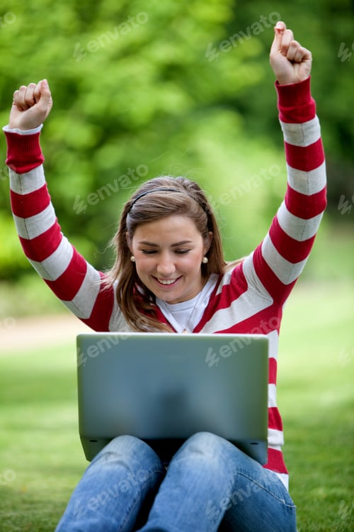 Preview: Excited Woman Smiling With A Laptop Outdoors